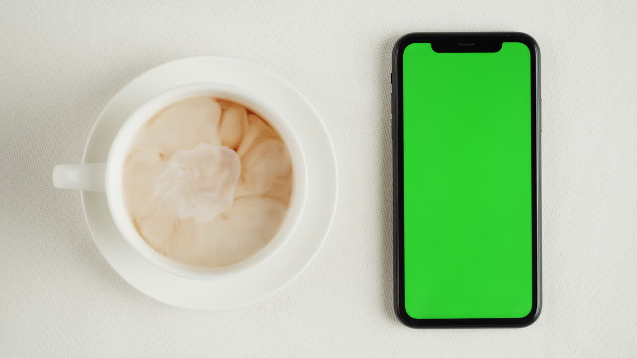 Tea and Smartphone on White Tabletop