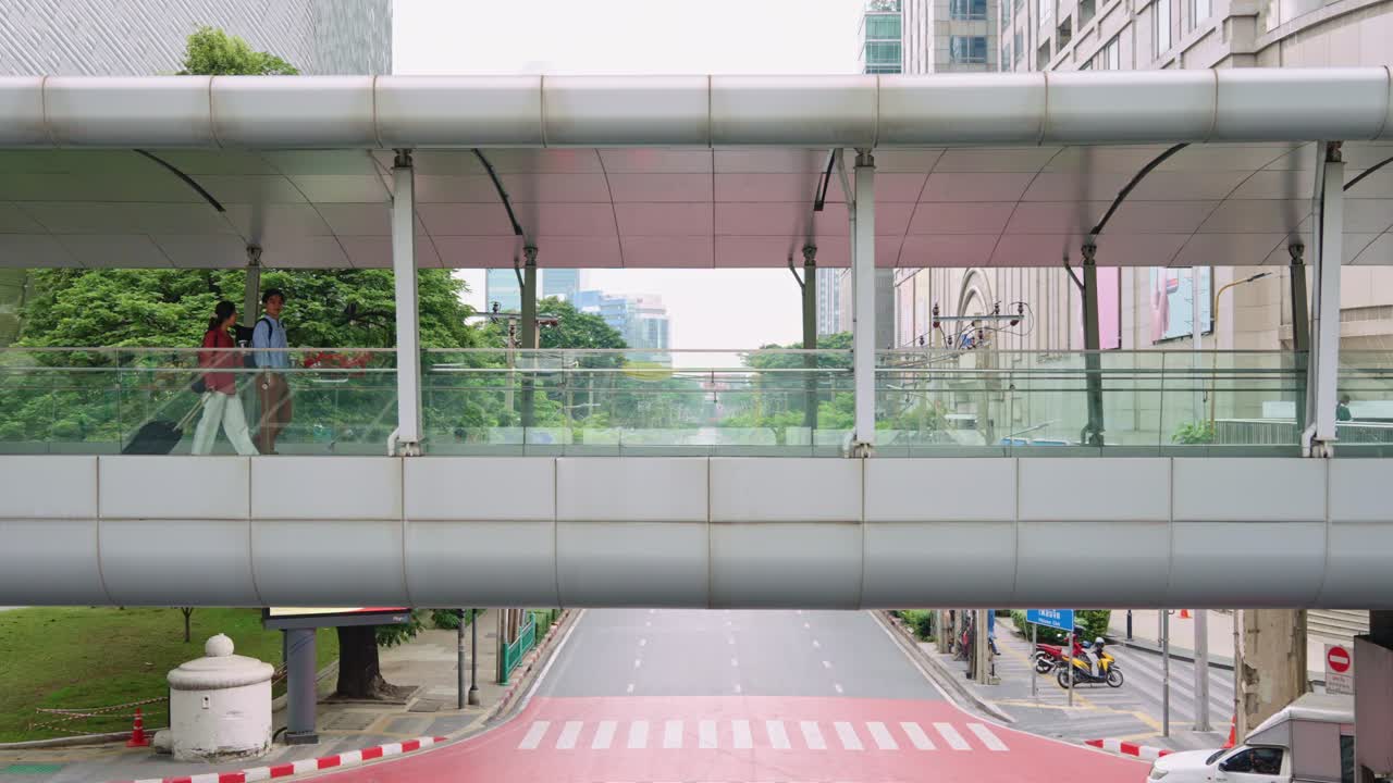 City pedestrian bridge with people and traffic