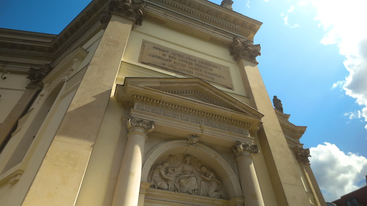 View through an entrance towards a historic Berlin church in a public square