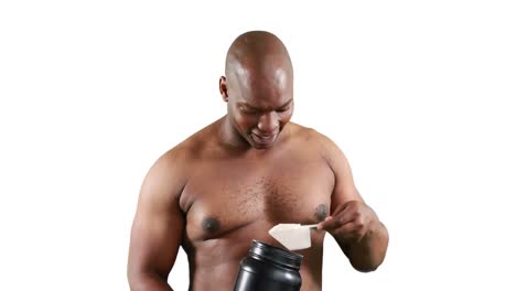 smiling muscular man holding protein