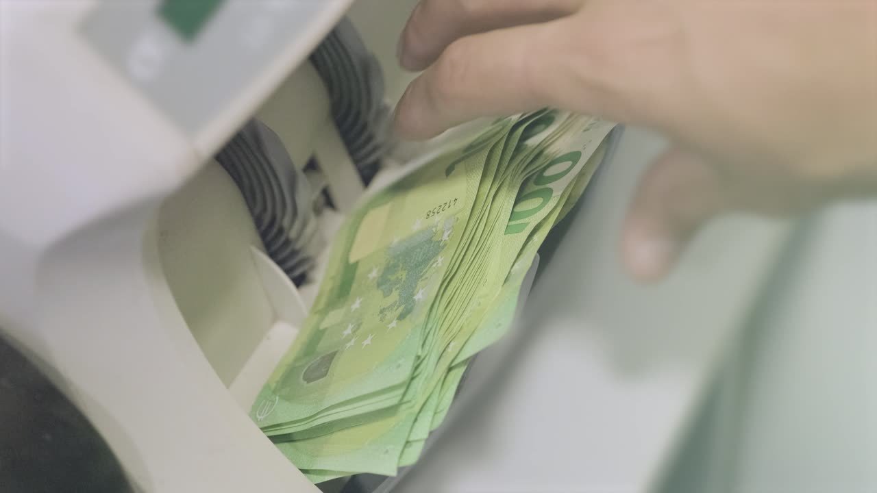 The calculating machine counts euro bills Thousand euro