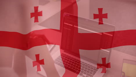 georgian flag animation over person using laptop in office setting