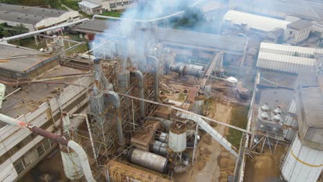 aerial view of wood processing plant with smokestack from production process polluting environment at factory manufacturing yard