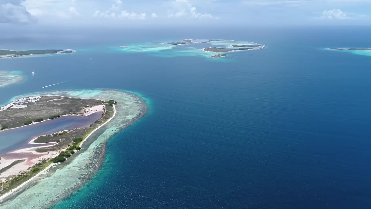 Moving-turn aerial view  beach cay  and-shallow-turquoise waters in the Caribbean sea in  Madrisky Los-roques National Park Venezuela