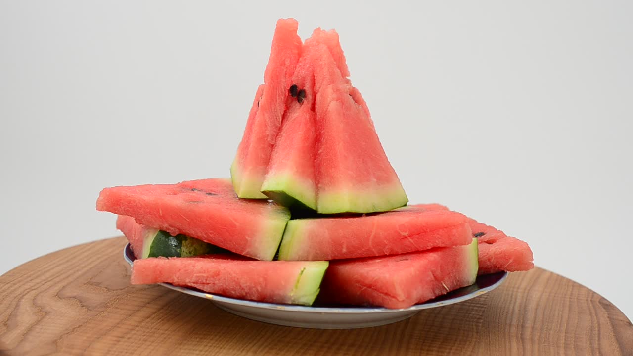 Shooting of a watermelon on a kitchen board. Shooting in the movement