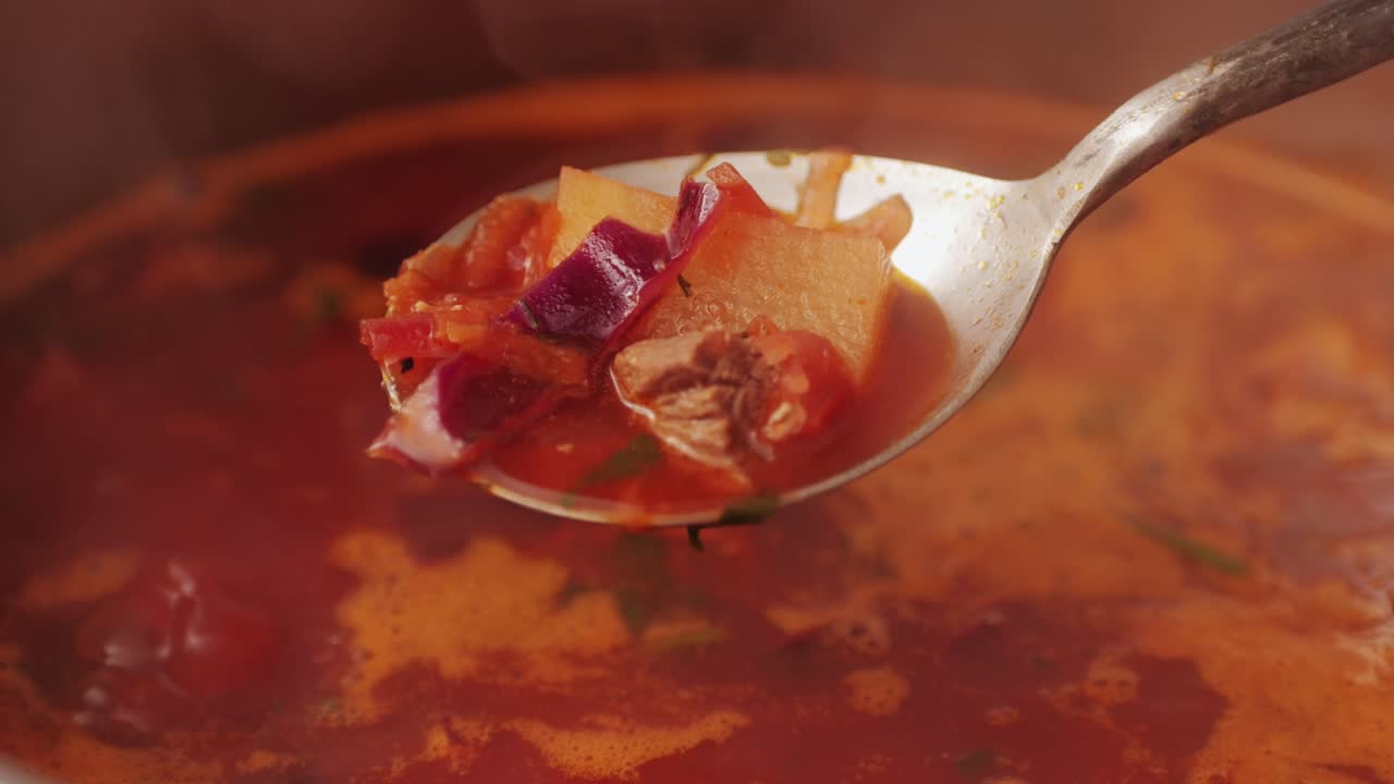 Beetroot soup, Cooking traditional national Russian, Ukranian soup Borsch close-up. Boiling red soup with vegetables and turkey meat and spices. Special red for Borsh from beet, tomatoes pasta