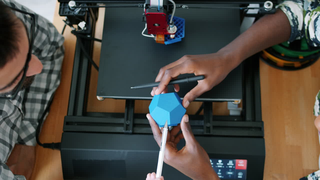 Two people working on a 3D printed object