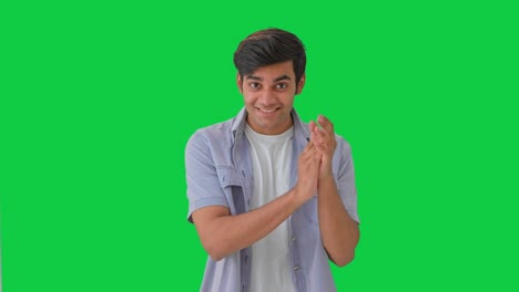 happy indian boy clapping and appreciating green screen