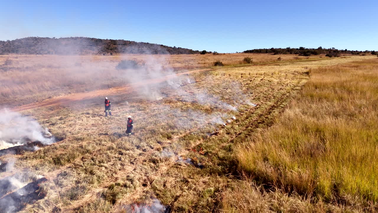 Drip torch used by workers to burn dry vegetation to make firetrail on farm