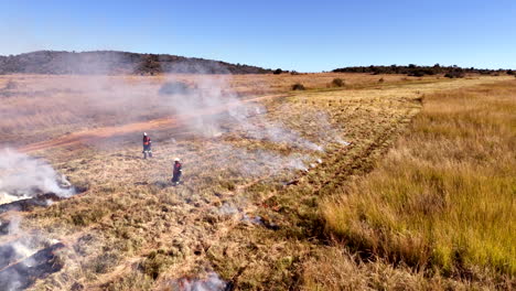 drip torch used by workers to burn dry vegetation to make firetrail on farm