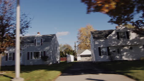 Driving-along-one-of-the-streets-in-the-city-of-Buffalo,-USA,-the-view-from-the-car-window-to-the-street-with-typical-houses