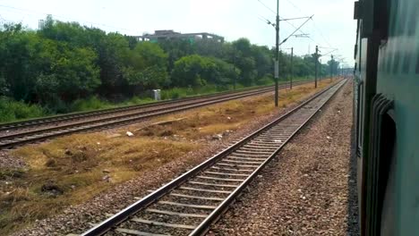 Indian-Blue-Train-Running-On-Track-During-morning,-Close-Up-Shot