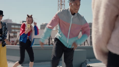 man breakdancing on rooftop at hip hop dance party performing crazy breakdance moves with friends dancing and celebrating