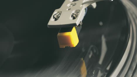 vinyl player turntable. a fragment of a rotating vinyl record, a stylus with a needle close-up. stopping a needle and a vinyl plate close-up. macro. view from above