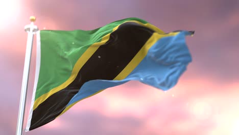 bandera de tanzania ondeando en el viento en lento al atardecer, bucle