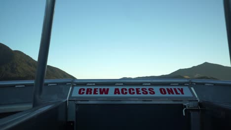 Early morning sunrise boat cruise in Queen Charlotte Sound, New Zealand with mountains in background