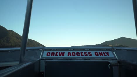 early morning sunrise boat cruise in queen charlotte sound, new zealand with mountains in background