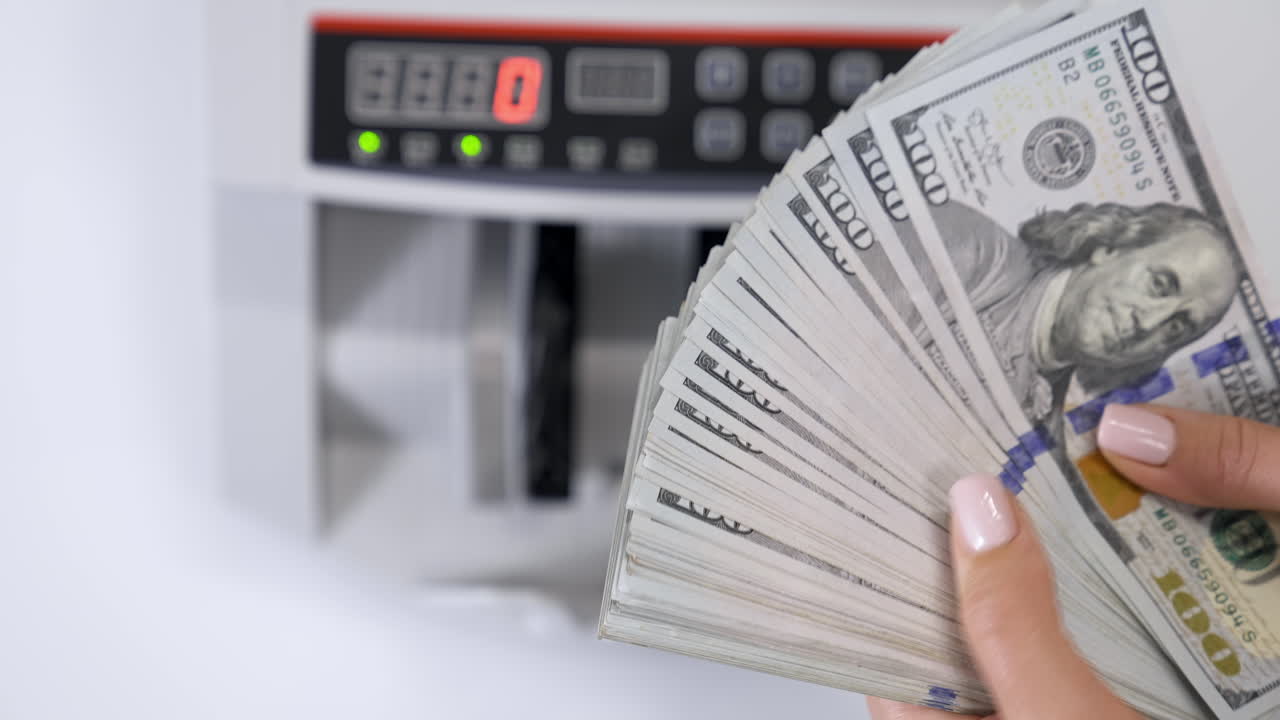 Closeup of business woman hand hands counting US dollar cash.