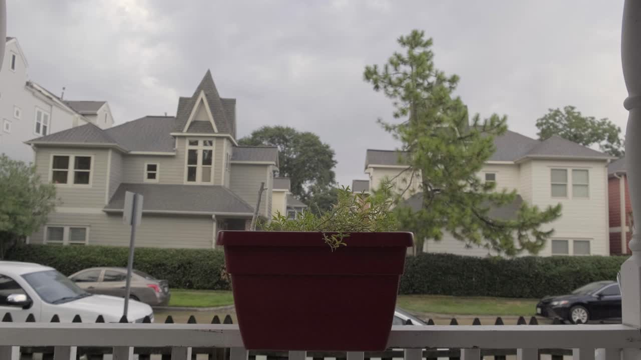 Rain falling in neighborhood over houses