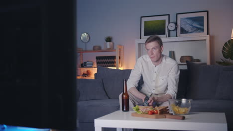 man watching tv at night