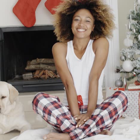 cute young woman and her dog at christmas