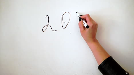 Handwriting-a-number-on-a-whiteboard,-the-current-year-of-2020