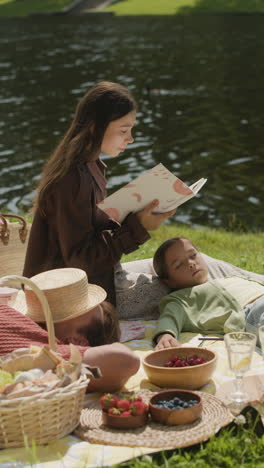children enjoying a summer picnic by the lake