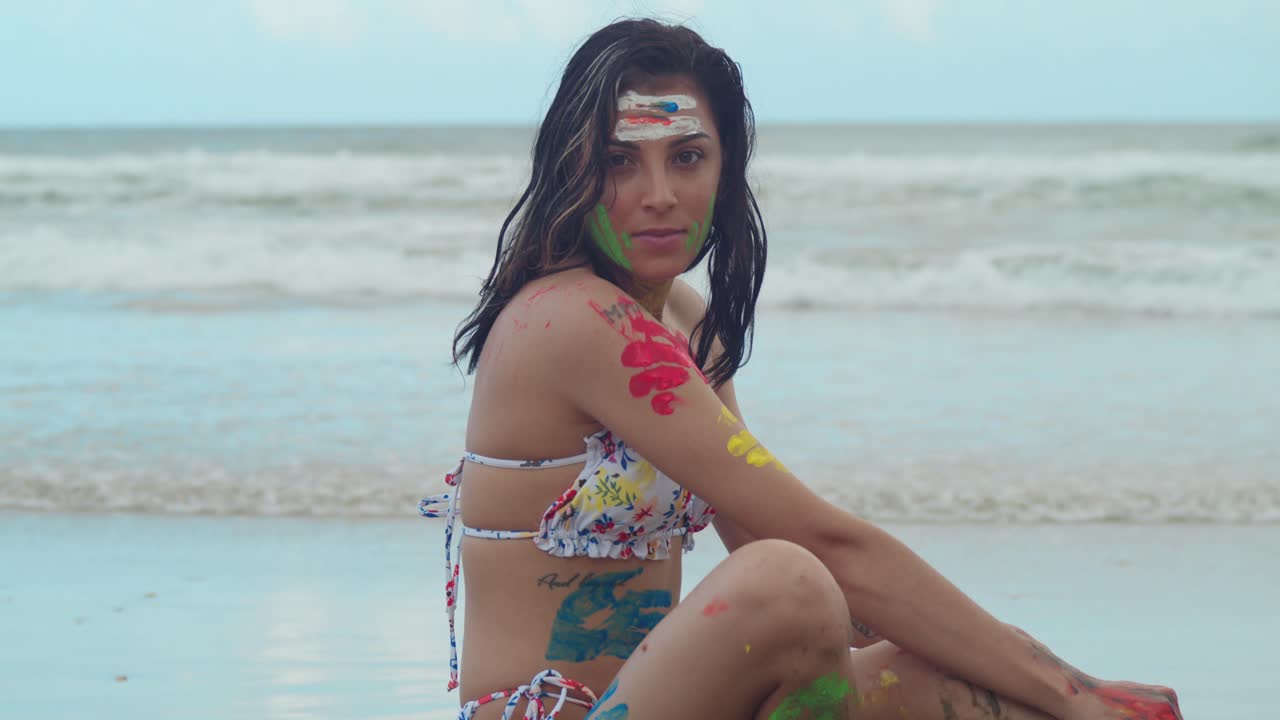 The Caribbean's tropical charm was enhanced by the presence of a young girl in a bikini, her body painted with vivid colors