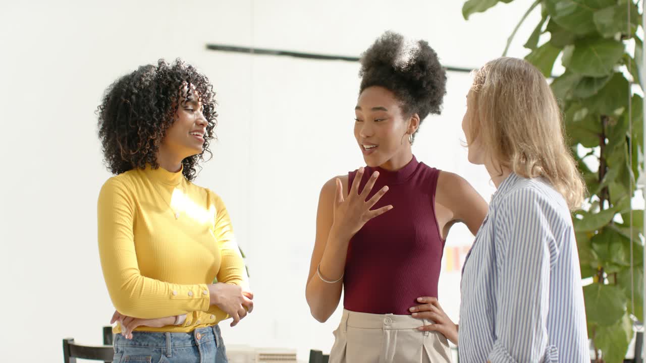 Diverse female team after intro in office center woman explaining pointing and counting by table