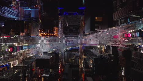 Aerial-birds-eye-overhead-top-down-view-of-cars-passing-through-Times-Square.-Visual-tourist-attraction-at-night.-Manhattan,-New-York-City,-USA