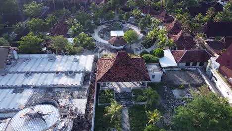 aerial view of a tropical resort with traditional bungalows and ongoing construction