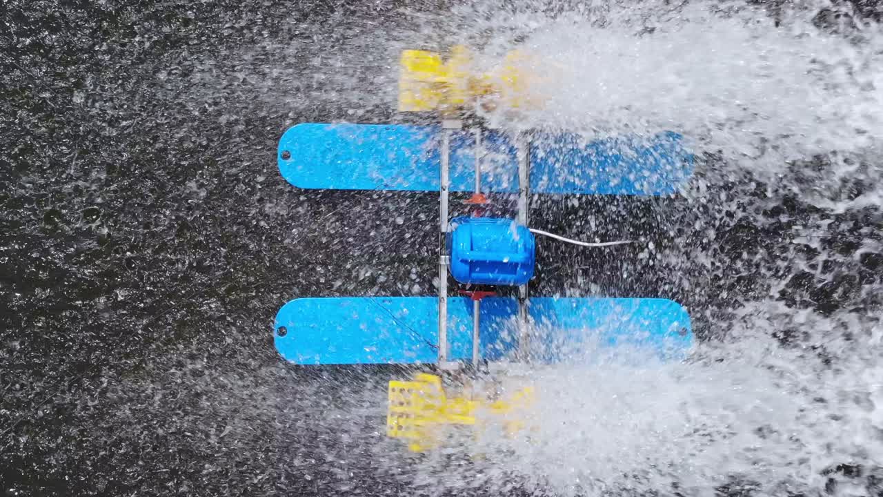 Mini watermill from above on a pond in Sovata. Water splashing. Overhead
