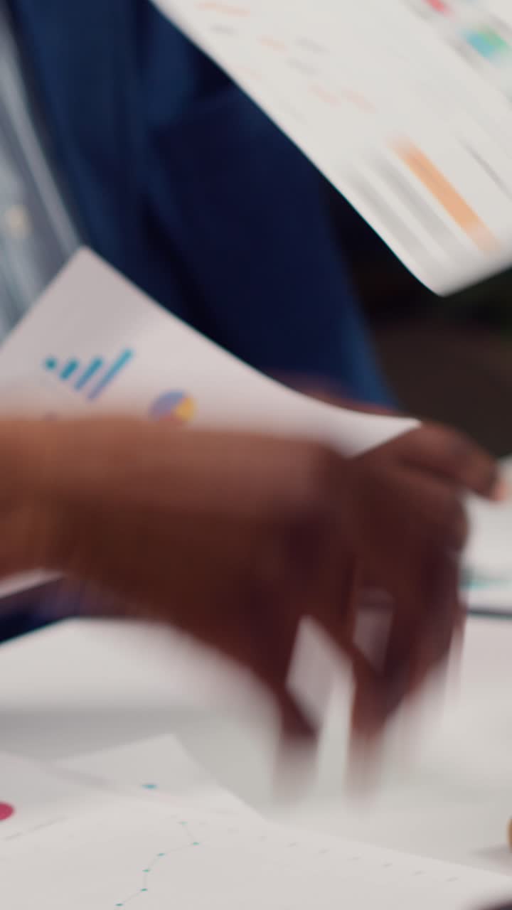 Business Professionals Analyzing Financial Charts and Data on Desk