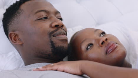 African-couple-talking-on-bed-in-morning