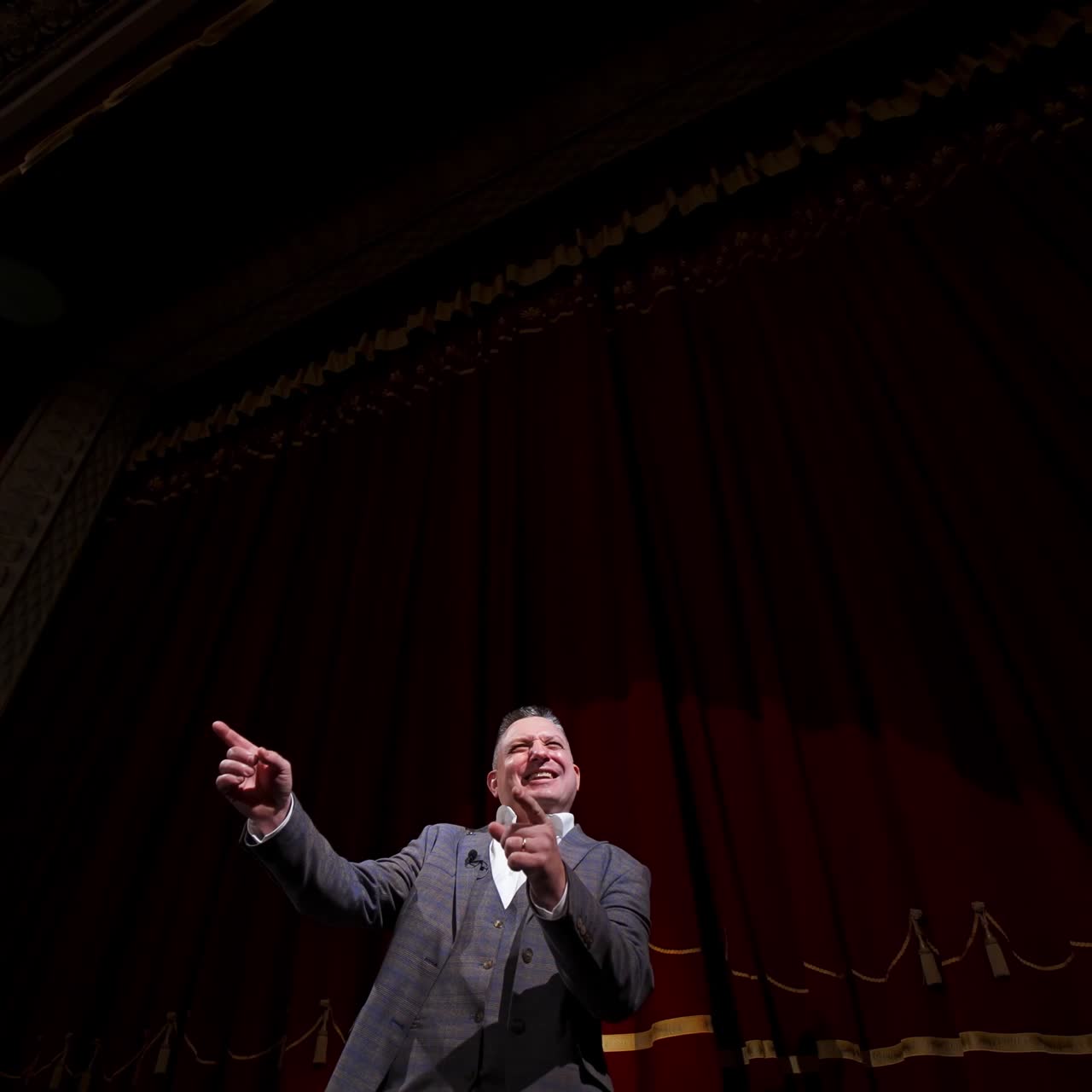 Businessman in theater says about politics and finance. Motivational Speaker