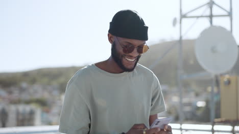 Phone,-texting-and-happy-black-man-on-rooftop