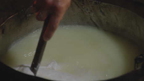 local artisan mixing natural chese curd prepared from scratch