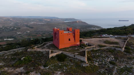 Aerial view orbiting the Fort Saint Agatha&#039;s Tower, golden hour in Malta