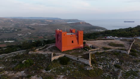 aerial view orbiting the fort saint agatha's tower, golden hour in malta