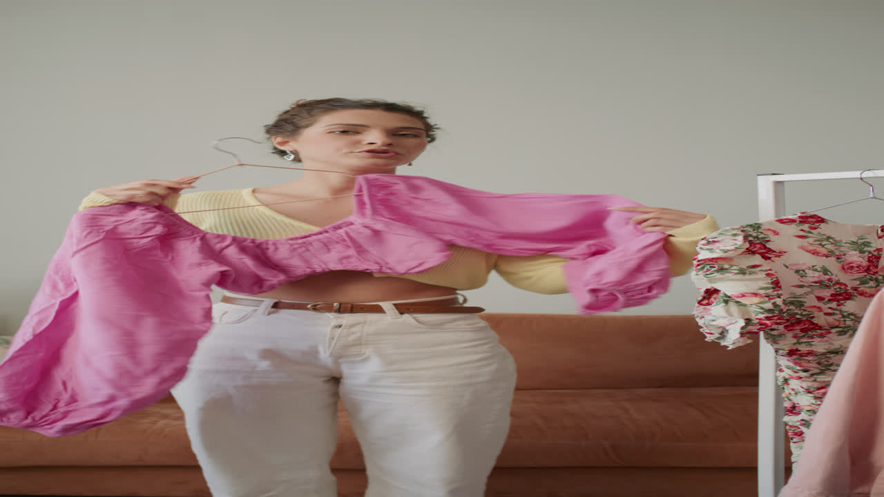 Female Fashion Blogger Demonstrating Pink Blouse during Content Recording