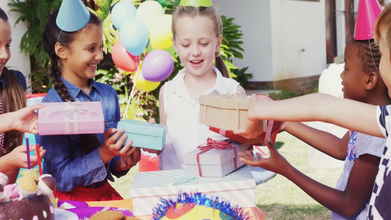 Smiling girl receiving gifts from friends 4k
