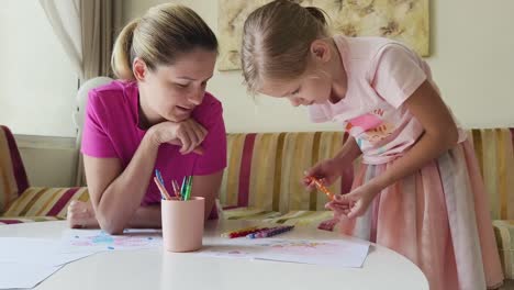 mother and daughter drawing together