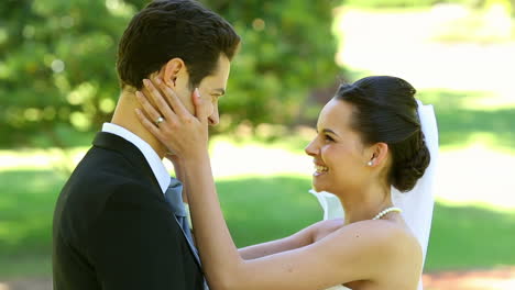 Happy-newlyweds-embracing-each-other-in-the-park