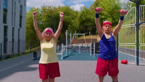 Elderly-grandmother-and-grandfather-pensioners-family-engaged-in-sports-doing-stretching-cardio