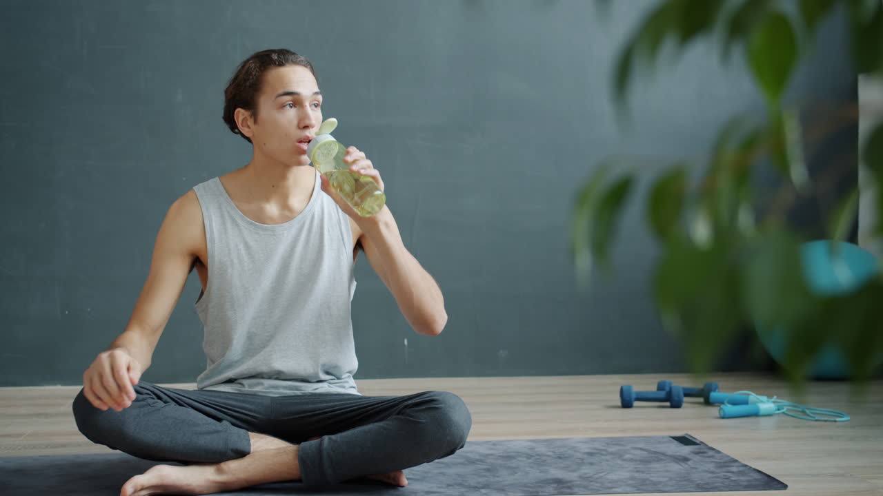 Man Drinking Water After Yoga