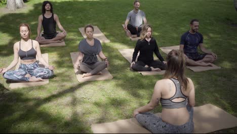 sporty people sitting in lotus position outdoor