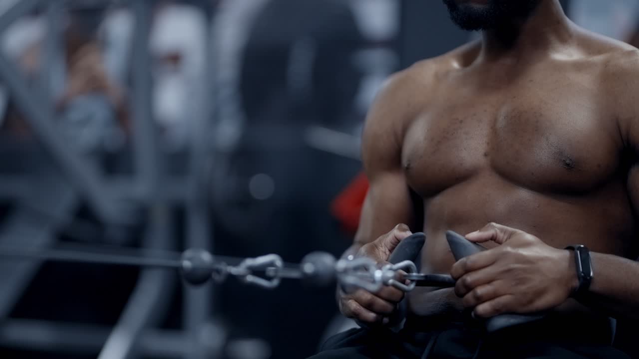 Fit African American man performing seated cable rows