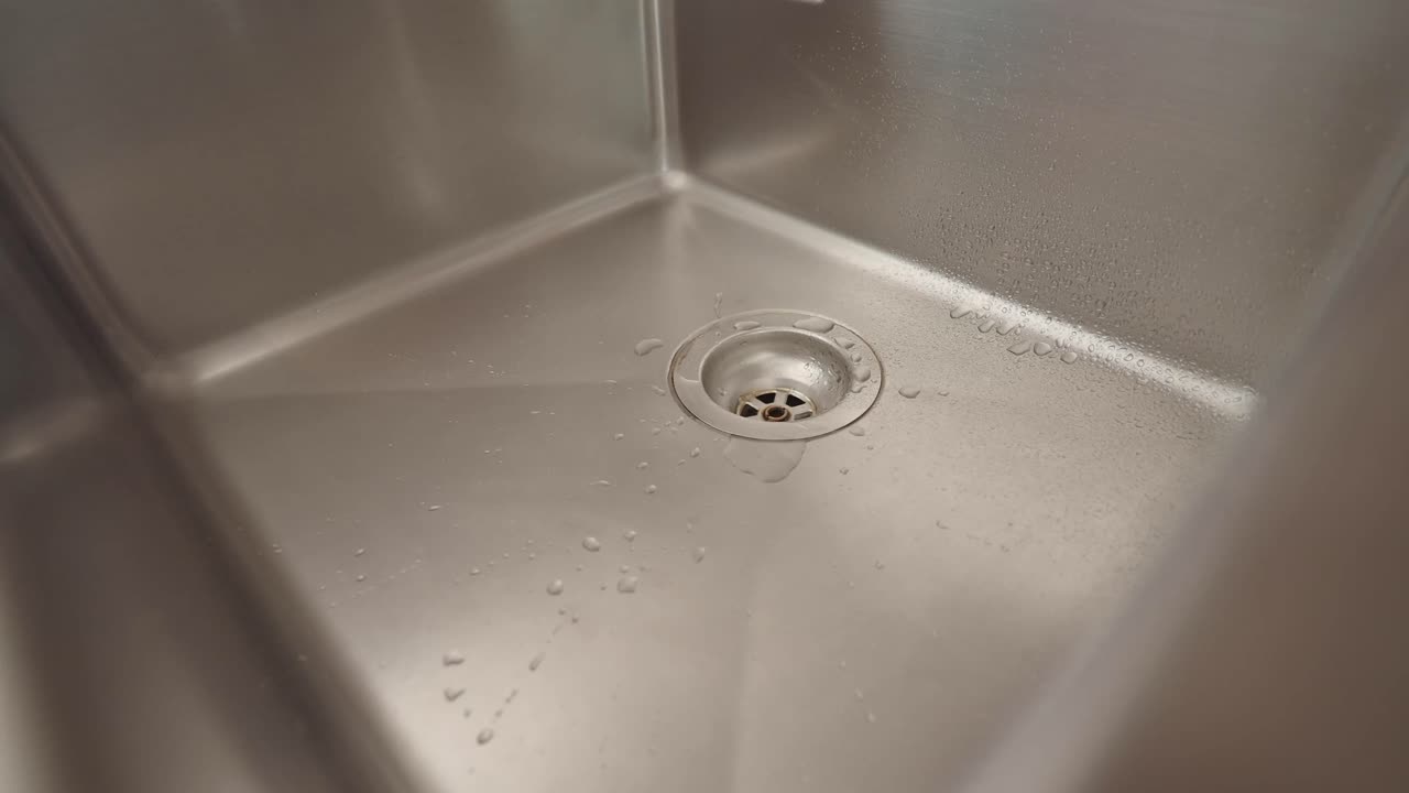 Water flowing into a stainless steel sink