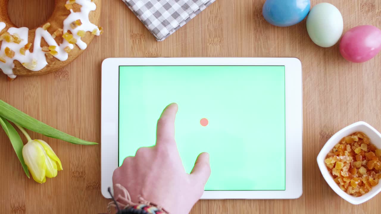 Woman's hand using a tablet with chroma key
