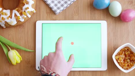 woman's hand using a tablet with chroma key